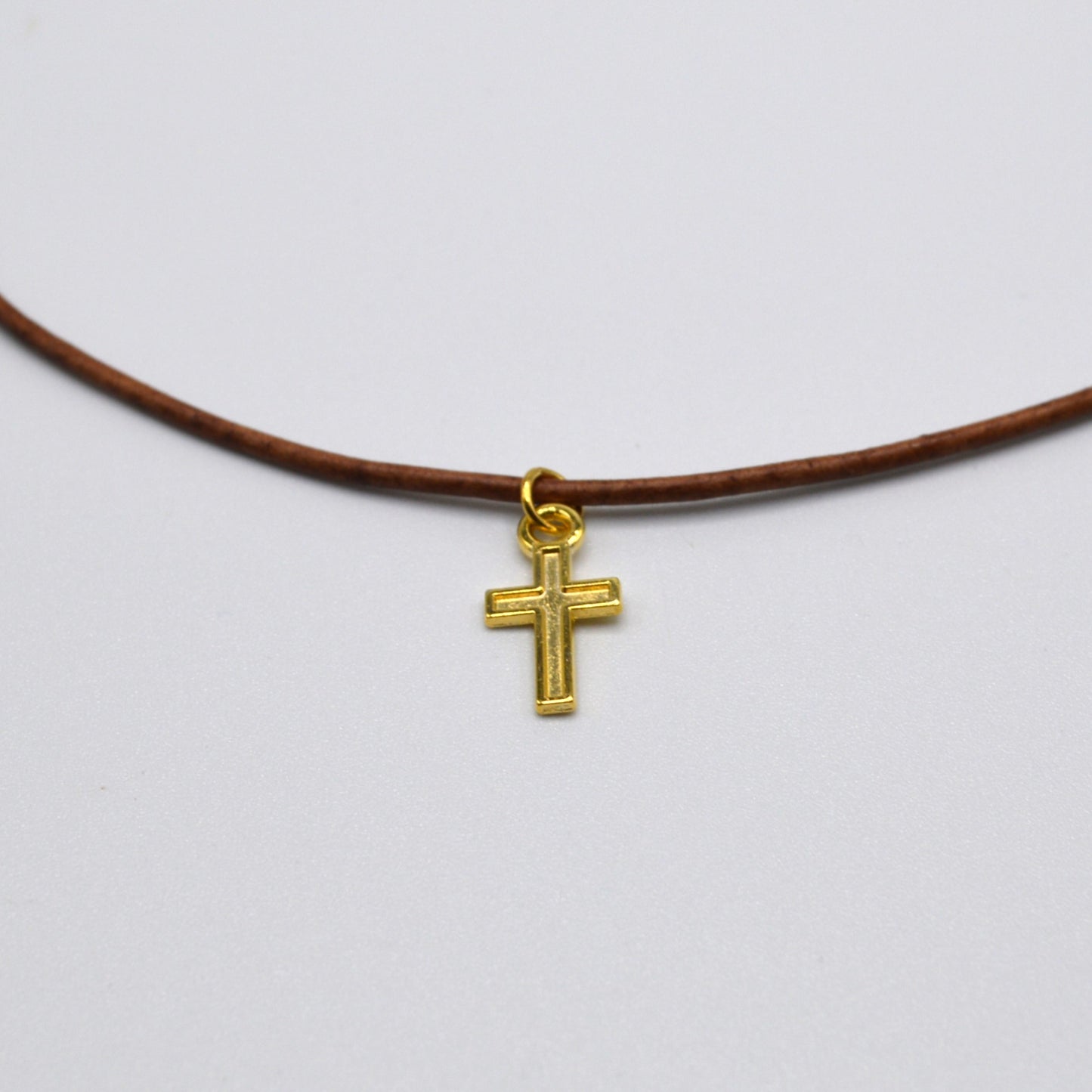 Gold Cross on a Leather Cord