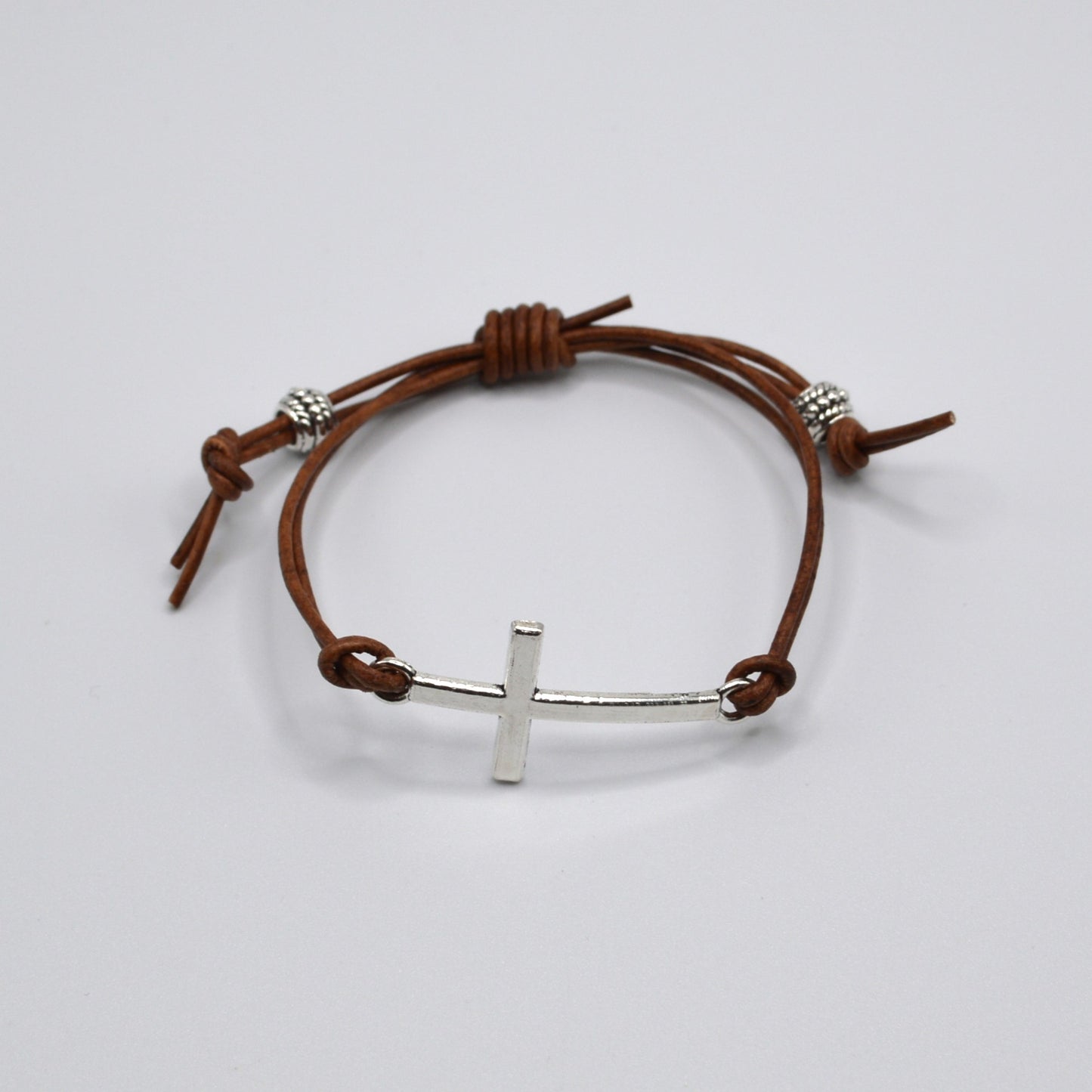 Silver Cross on a Leather Cord Bracelet